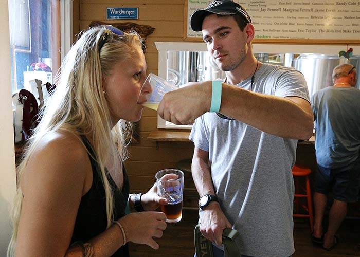 Cassie Hoffman and Matt Feist share a taste of beer during a tour at Fannin Brewing.