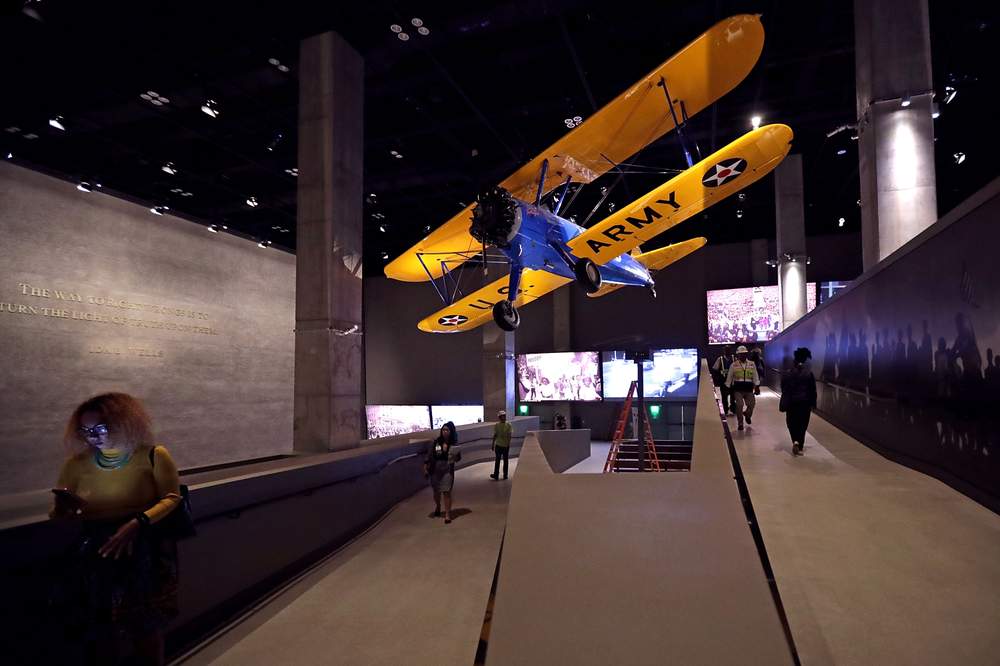 The Spirit of Tuskegee, a PT-13 Stearman biplane flown by Tuskegee Airmen training to fight in WWII, hangs from the ceiling. (Chip Somodevilla\/Getty Images)
