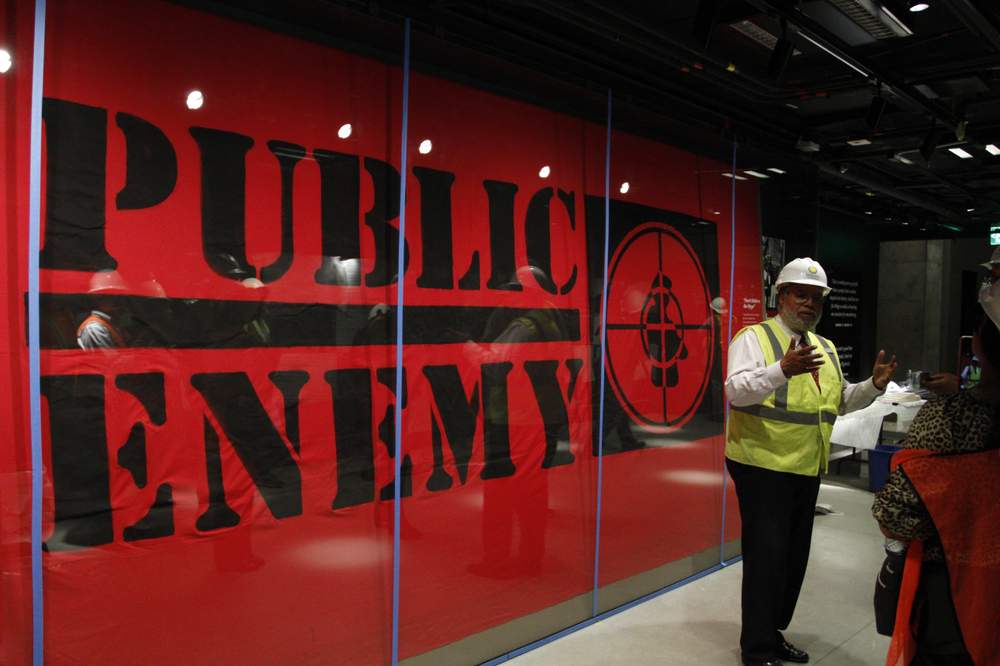 Museum Director Lonnie Bunch stands in-front of an art piece representing hip-hop group Public Enemy on July 18, 2016. (AP Photo\/Paul Holston)