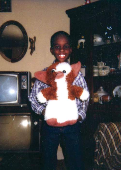 Fahamu, 9, with his Gizmo stuffed animal in 1984 in South Carolina. From a very early age Fahamu excelled in school and developed a passion for art. At the age of 9, he declared his future as an artist of note. PHOTO COURTESY OF PECOU FAMILY.