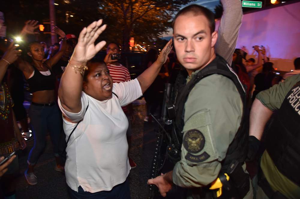 A woman complains to a police officer on Williams Street during the  July 8, 2016, Atlanta protests. PHOTO: Brant Sanderlin \/ AJC