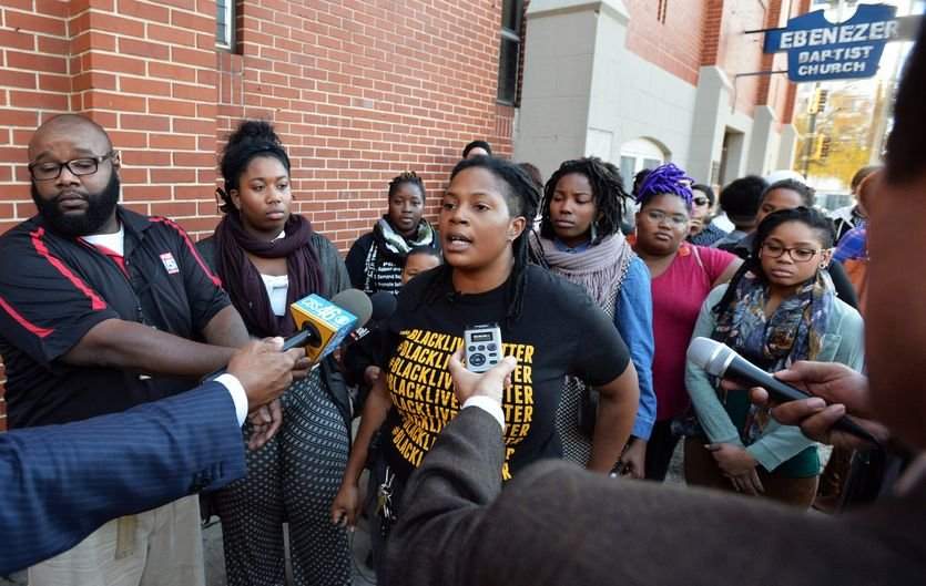 Atlanta Black Lives Matter activist and organizer Mary Hooks (center) speaks to the media outside Ebenezer Baptist Church in 2014.PHOTO: Brant Sanderlin \/ AJC