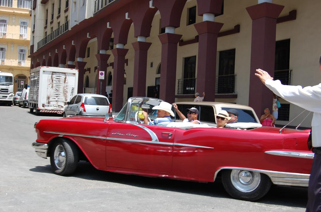 A red convertible taxi in downtown Havana is among the classic American autos seen all around the city.Photo: Katie Leslie / kleslie@ajc.com