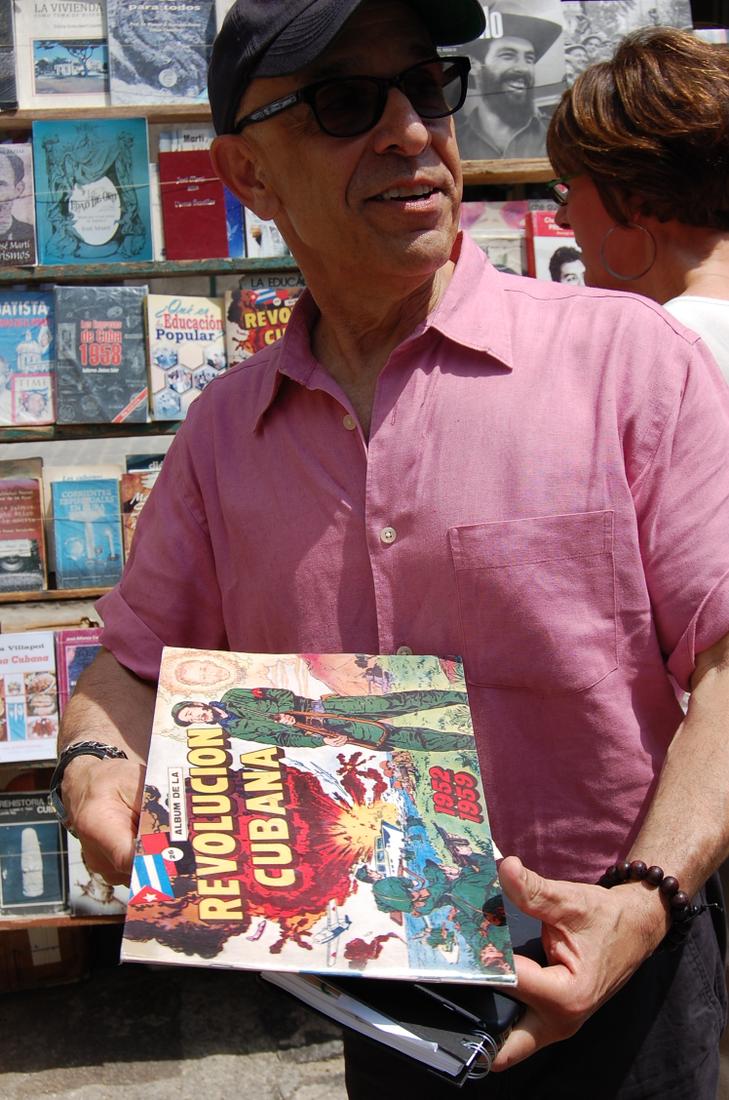 Jorge Fernandez shows a replica of a '60s-era Revolution-themed comic he was given as a child after the Castro regime took control.Photo: Katie Leslie / kleslie@ajc.com