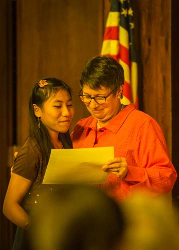 En Kawli receiving her diploma at graduation from her middle school, The Global Village Project, a school for refugee girls.