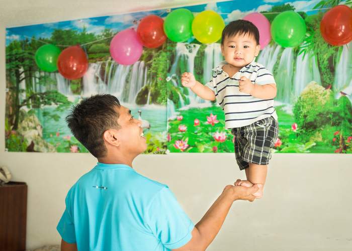 Pai playing his his son, Samuel, who is the only member of the family born in the U.S.