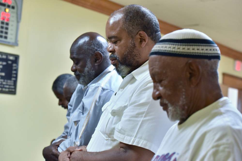 Ahmed Najee-ullah, second from right, prays with fellow congregants at the Masjid Al-Mu’minun mosque. He converted to Islam during the Civil Rights movement.PHOTO: Hyosub Shin \/ AJC