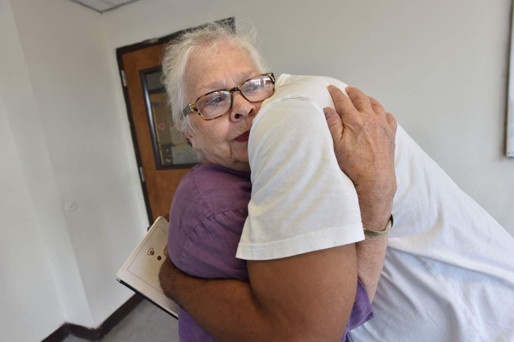 Anita Beaty gets a hug from Troy Harris after a meeting with Transitional Housing Program participants at the Peachtree-Pine shelter on July 13,  2017. \/ Photo by Hyosub Shin \/ hshin@ajc.com