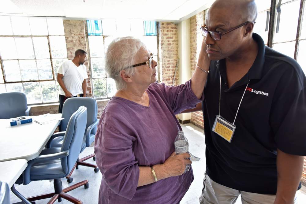 Anita Beaty comforts Aaron Harper after a meeting with Transitional Housing Program participants at the Peachtree-Pine shelter on July 13,  2017. \/ Photo by Hyosub Shin \/ hshin@ajc.com