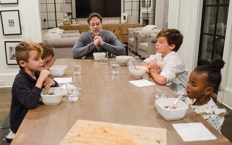 Dana's husband Angelo (center) and their children (from left) Ryder, 6, Lincoln, 9, Hudson, 11, and Asher, 4, say their prayers before dinner.