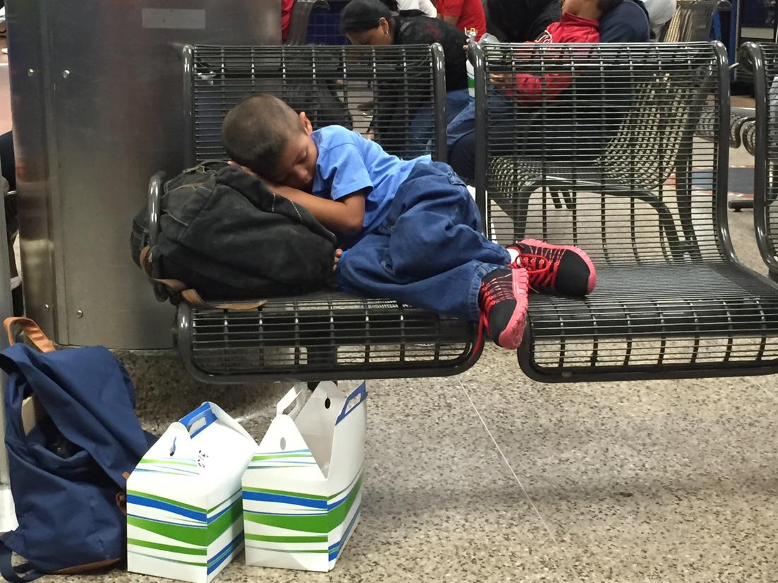 A child sleeps early one morning at the bus station while waiting for a bus to take him to stay with his family while they fight to stay in the U.S.Jeremy Redmon\/jredmon@ajc.com