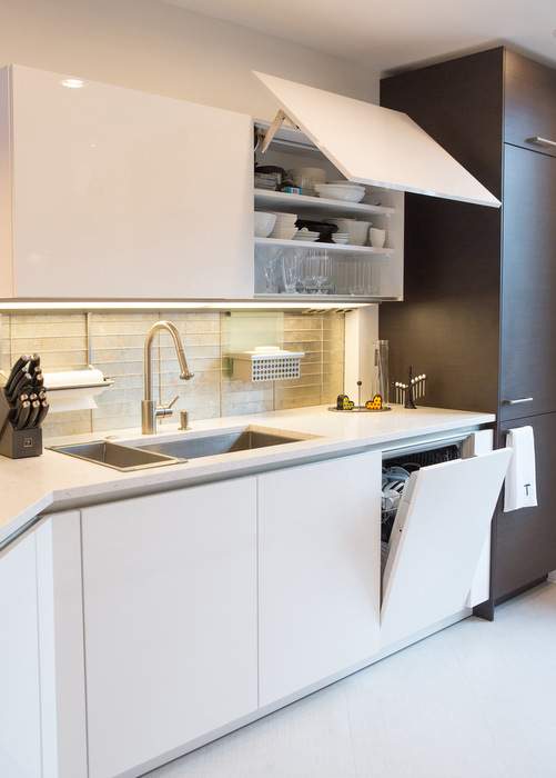 This condo in the Luxe has cabinets that open upward for more efficient use of the space.