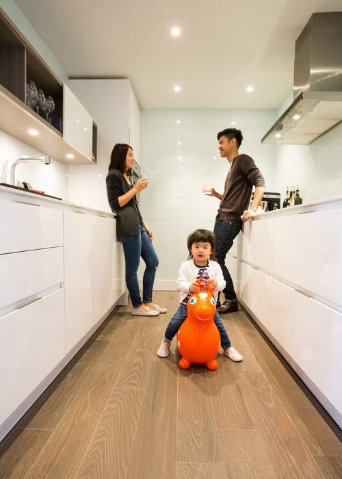 Kevin Kao, his wife Vicky Kao and their daughter Mila Kao in their condo at Colony House in Midtown.