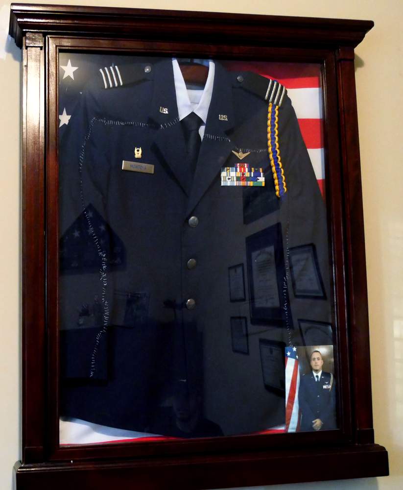 Ignacio's grandmother stitched back together the AFROTC uniform Ignacio was wearing the night he was injured. It has since been framed and hangs on the wall of his apartment. \/ Photo by Hyosub Shin \/ hshin@ajc.com