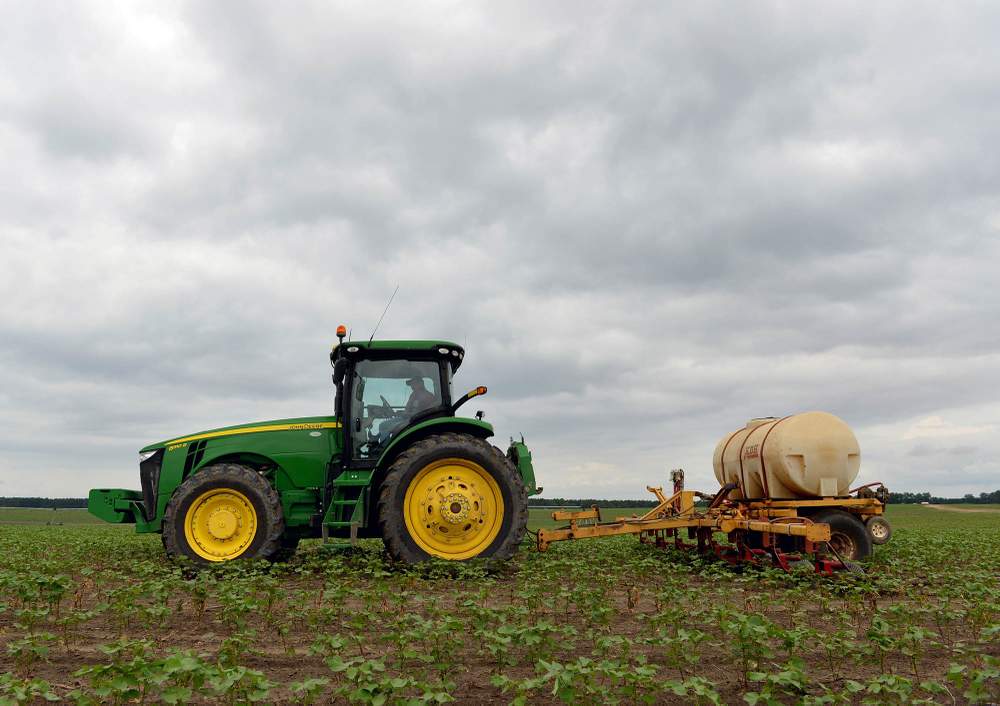 Liquid nitrogen is applied to a cotton field in Vienna. Photo: Brant Sanderlin / bsanderlin@ajc.com