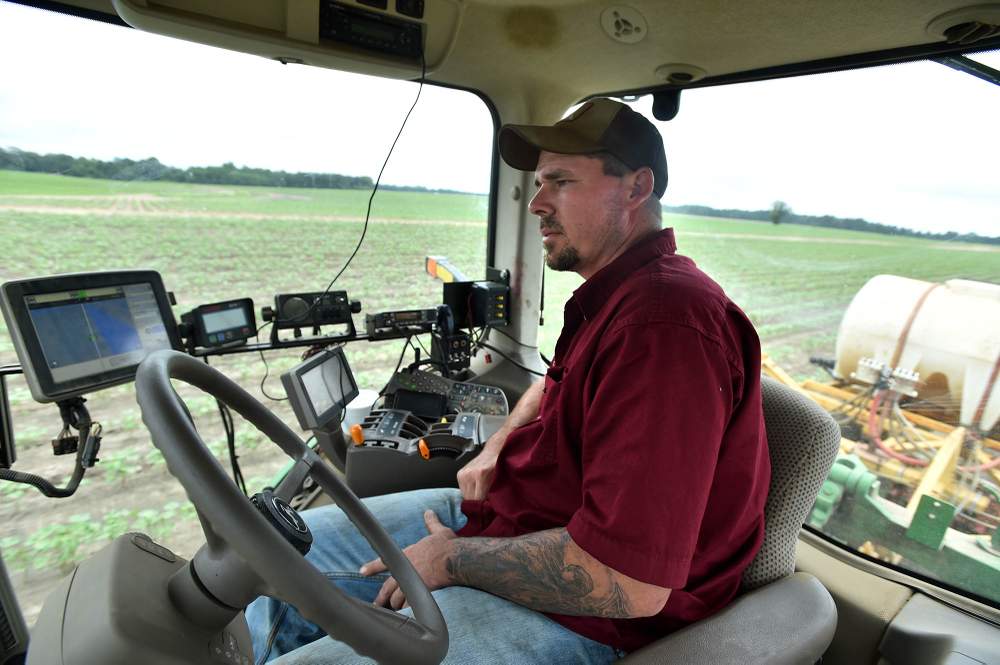 Todd Whitfield monitors the application of  liquid nitrogen to a cotton field in Vienna. Photo: Brant Sanderlin \/ bsanderlin@ajc.com