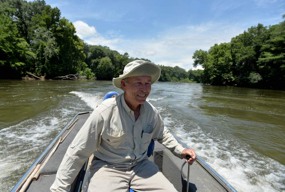 Glenn Cox guides his boat up the Flint River.Photo: Brant Sanderlin / bsanderlin@ajc.com