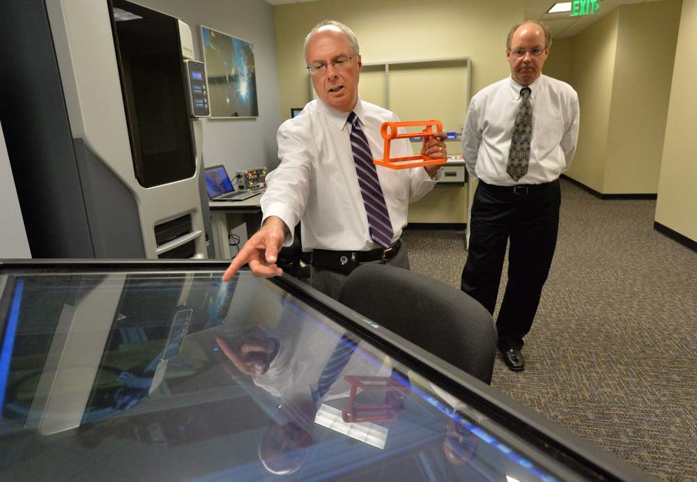 <strong>Vic Desmarais</strong>, Director of Advanced Manufacturing, explains a process as Millard Davis (right), training coordinator, looks on at Georgia QuickStart Headquarters. The economic development incentive program benefits affiliated employers as well as the state's technical colleges.<br /><br /><strong>PHOTO: Hyosub Shin / AJC</strong>