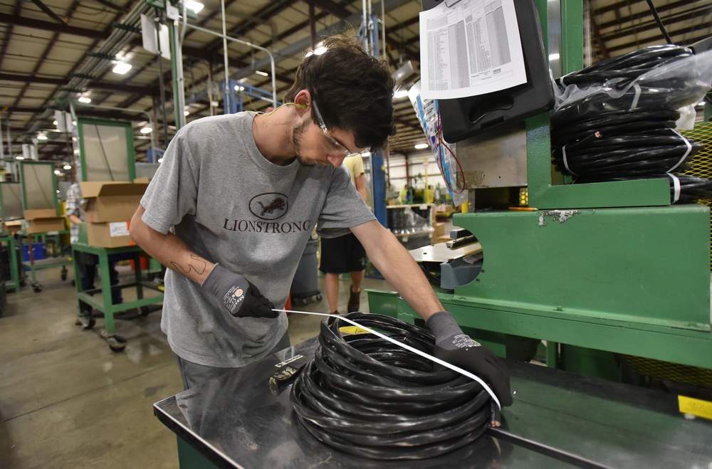 <strong>Zach Harness</strong>, 17, a student at Villa Rica High School, works at packing a product at Southwire's 12 for Life Carrollton Facility. He works a regular shift at Southwire before taking afternoon courses at the factory.<br /><br /><strong>PHOTO: Hyosub Shin / AJC</strong>