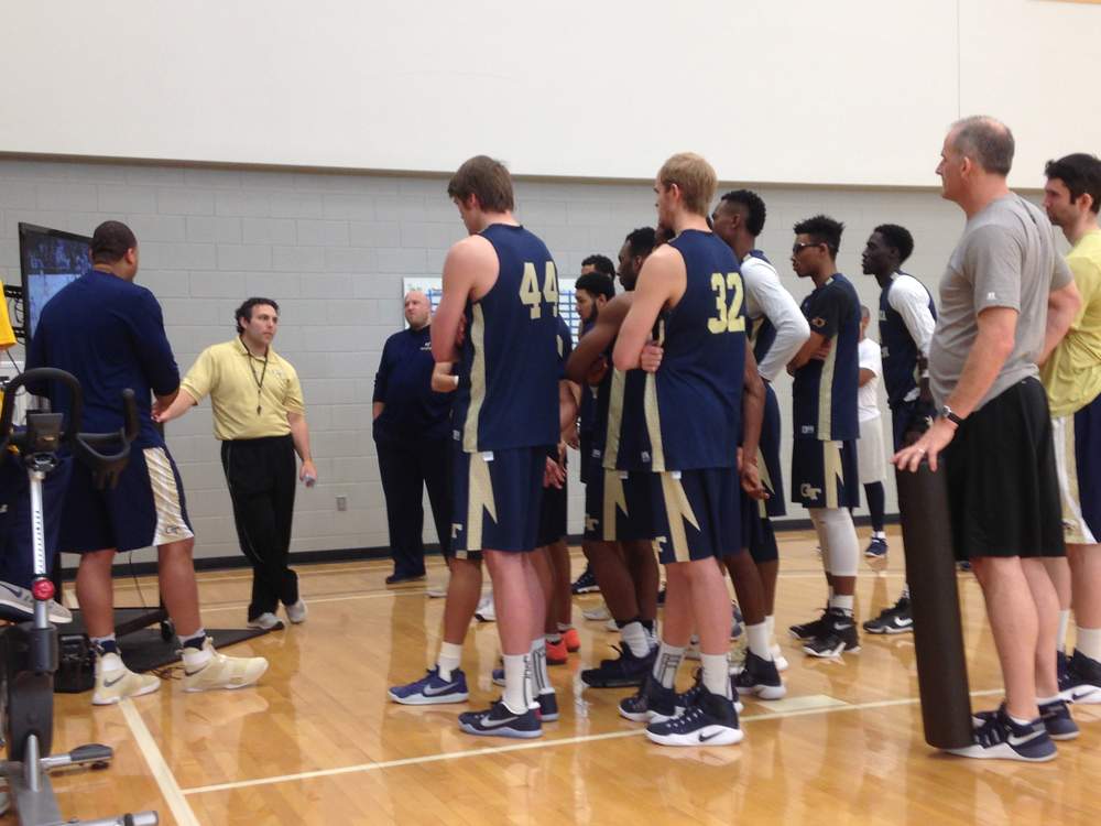 Georgia Tech coach Josh Pastner (yellow polo shirt) and assistant coach Tavaras Hardy (blue shirt, back to camera) show players Wake Forest game video at the Zelnak Center before practice Friday, Feb. 3, 2017. (Ken Sugiura\/AJC)