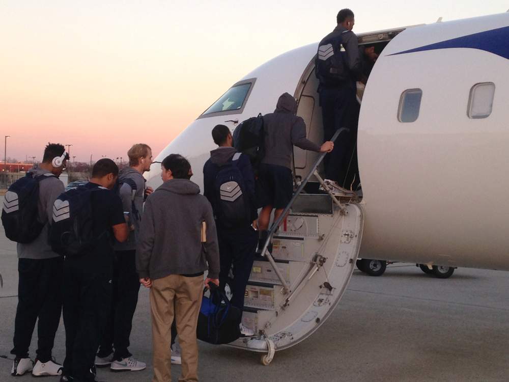 Georgia Tech players board their charter flight to Winston-Salem, N.C., at Hartsfield-Jackson International Airport Friday, Feb. 3, 2017. The ceiling of the charter jet was 6 feet, 1 inches. Tech's tallest player is 6-foot-10. (Ken Sugiura\/AJC)