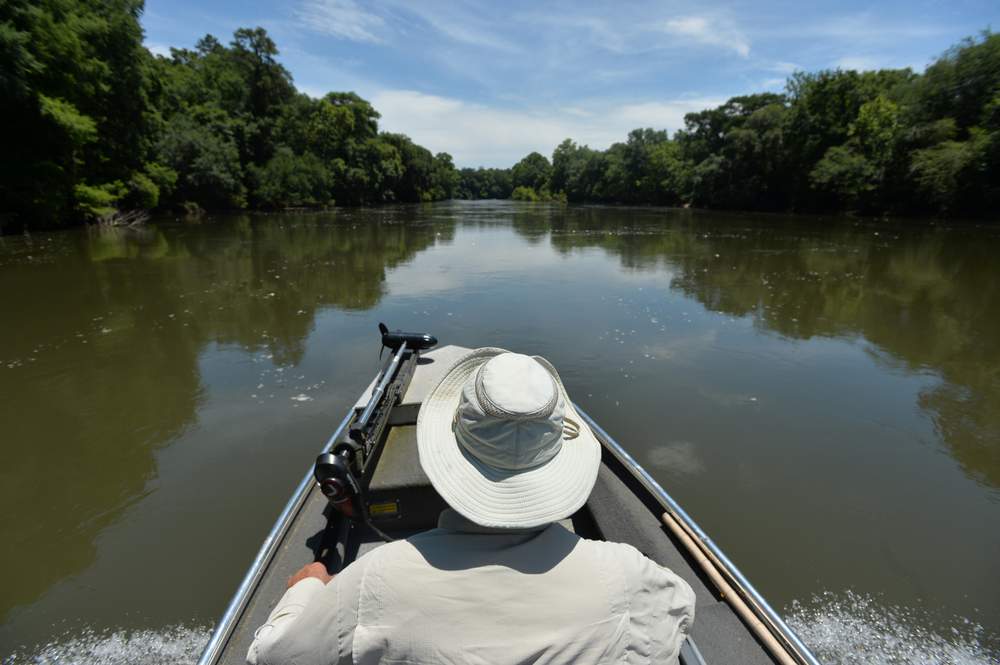 Glenn Cox, a fifth-generation farmer, guides his boat up the Flint River. "Everybody is fighting over the same water" Cox said.   (Brant Sanderlin \/ bsanderlin@ajc.com)