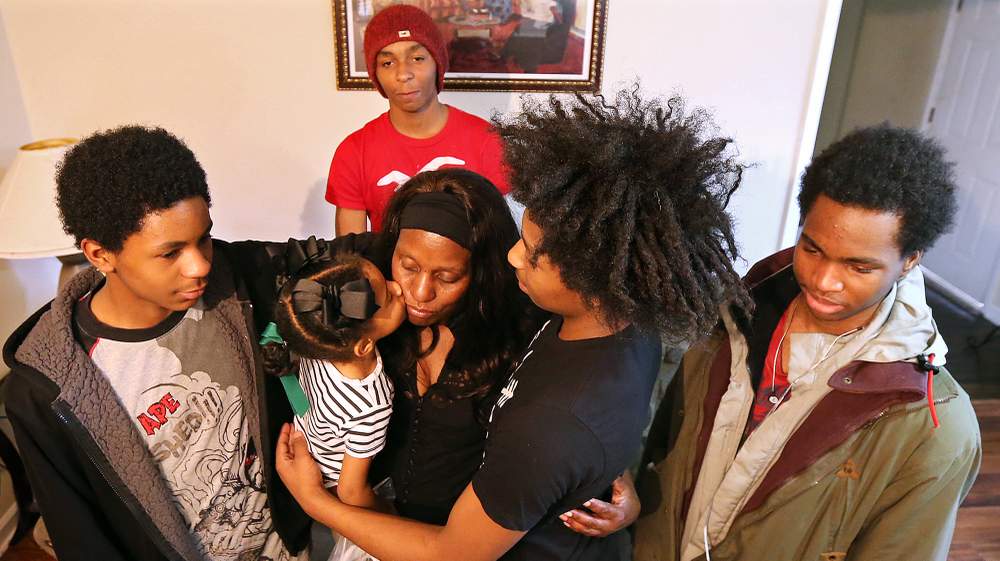 Grandchildren C.J. (from left), 14, Trinity, 3, Maleak, 13, Jalen, 16, and Markey, 18, gravitate around Loretta Jenkins in their living room.
