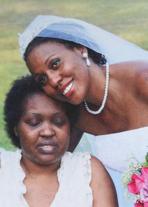 During the wedding of a brief second marriage, Loretta embraces her first-born child, Nicole Phang, shortly before she died from cancer. Family photo