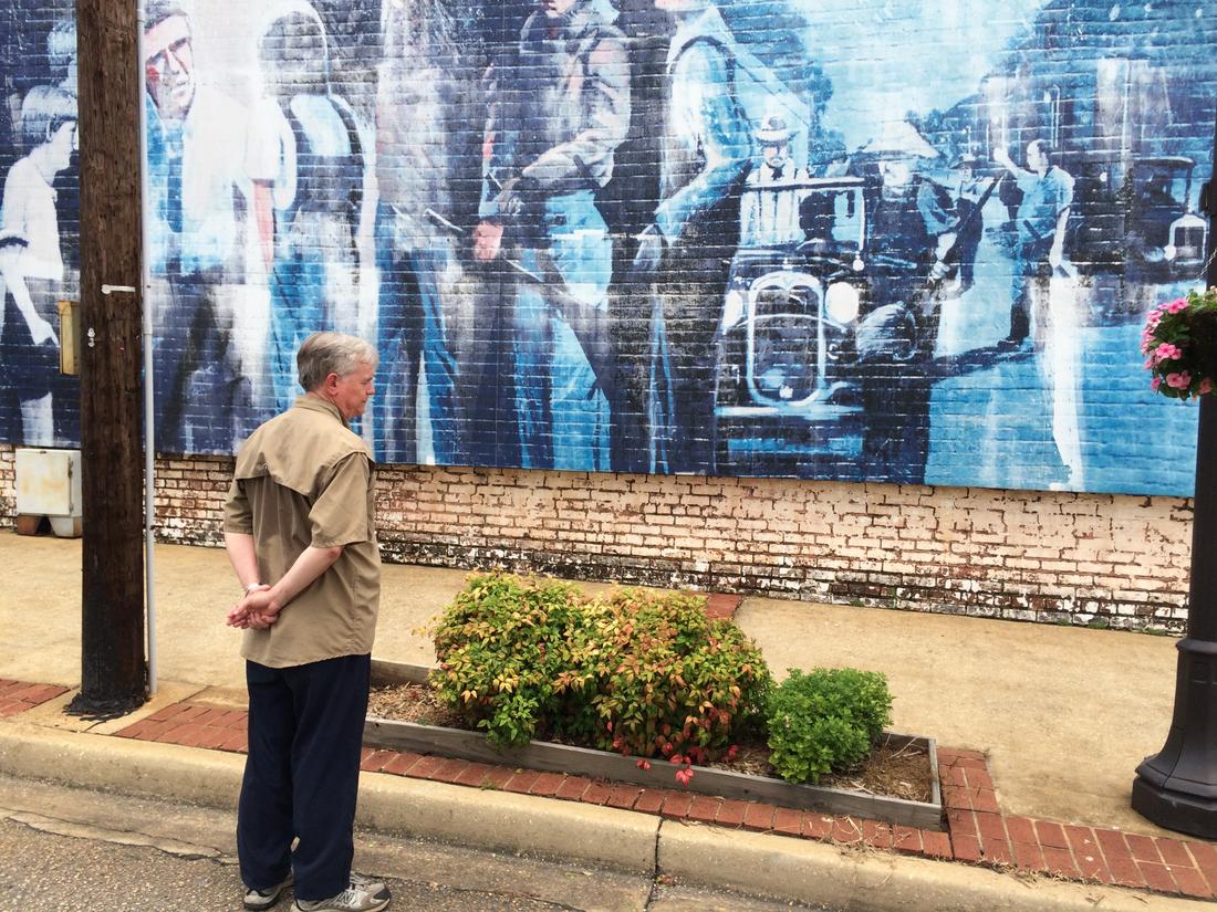 Downtown Monroeville is decorated with Mockingbird-themed murals, including this one, depicting the scene in which Atticus (with the help of Scout) turns aside the mob at the jail. Photo: Bo Emerson
