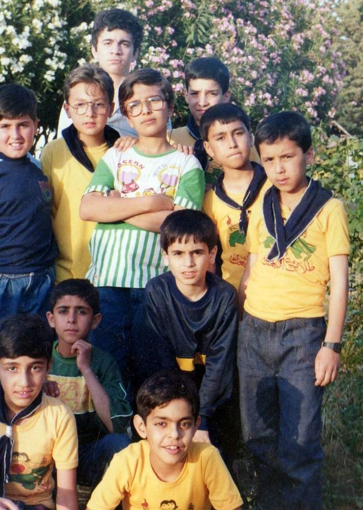 Heval (center) with his schoolmates in Syria. Contributed photo