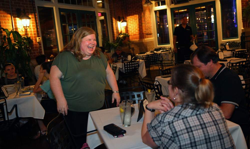 Hurricane Katrina evacuee Shannon Drawe interacts with customers at her brother's restaurant,  Atkins Park Restaurant &amp; Bar,  where she's the general manager. SEAN MCNEIL