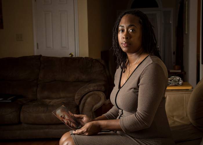 O’Neil’s girlfriend Chenneil Brown, holding a photo of the boxer at her home in Lithonia, said his treatment for bipolar disorder turned him back into a “gentle giant.” Steve Schaefer\/ Special