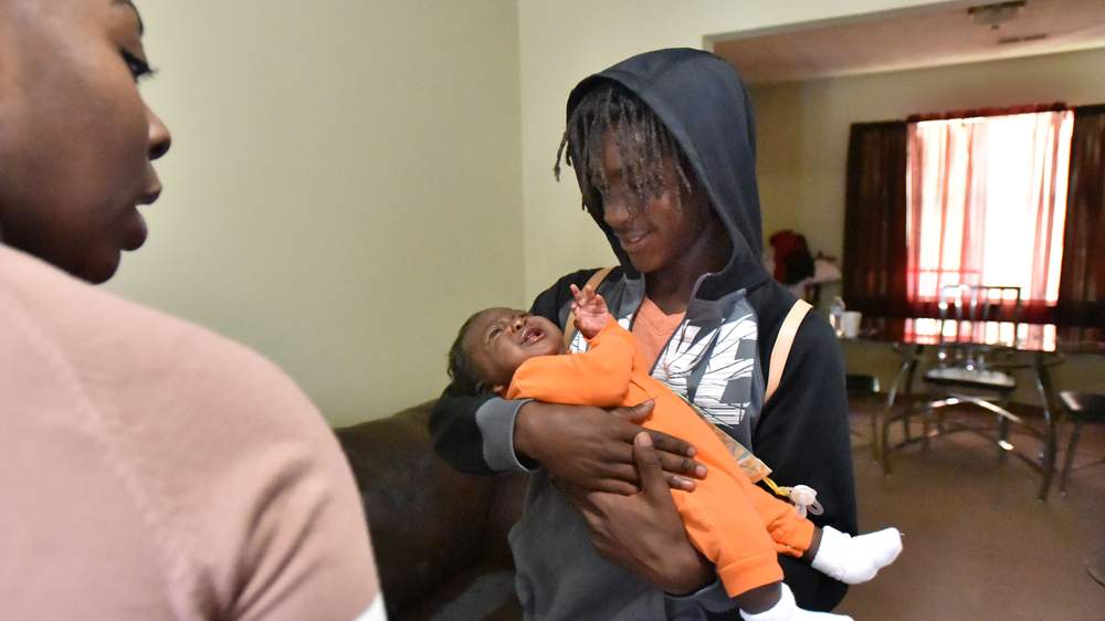 Jeremy Griffin holds his baby sister Dunya Griffin as his mother Chartisia Griffin watches. (Hyosub Shin \/ hshin@ajc.com)