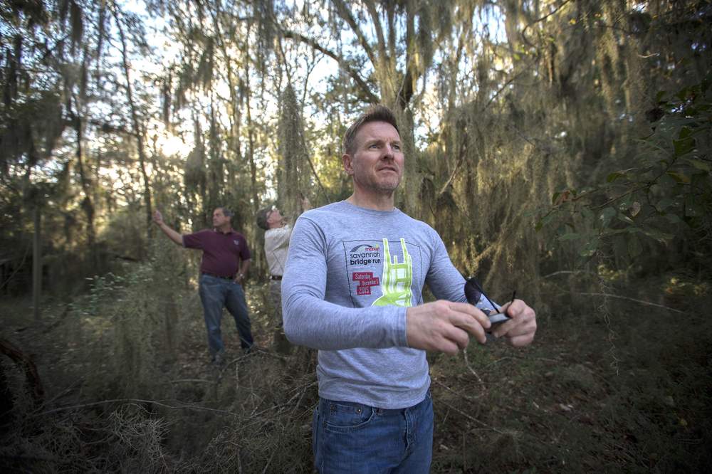 Stan Deaton, Senior Historian at the Georgia Historical Society,  snaps a photo of the view of the Savannah River from the Mulberry Grove plantation site.  (Stephen B. Morton\/AJC)