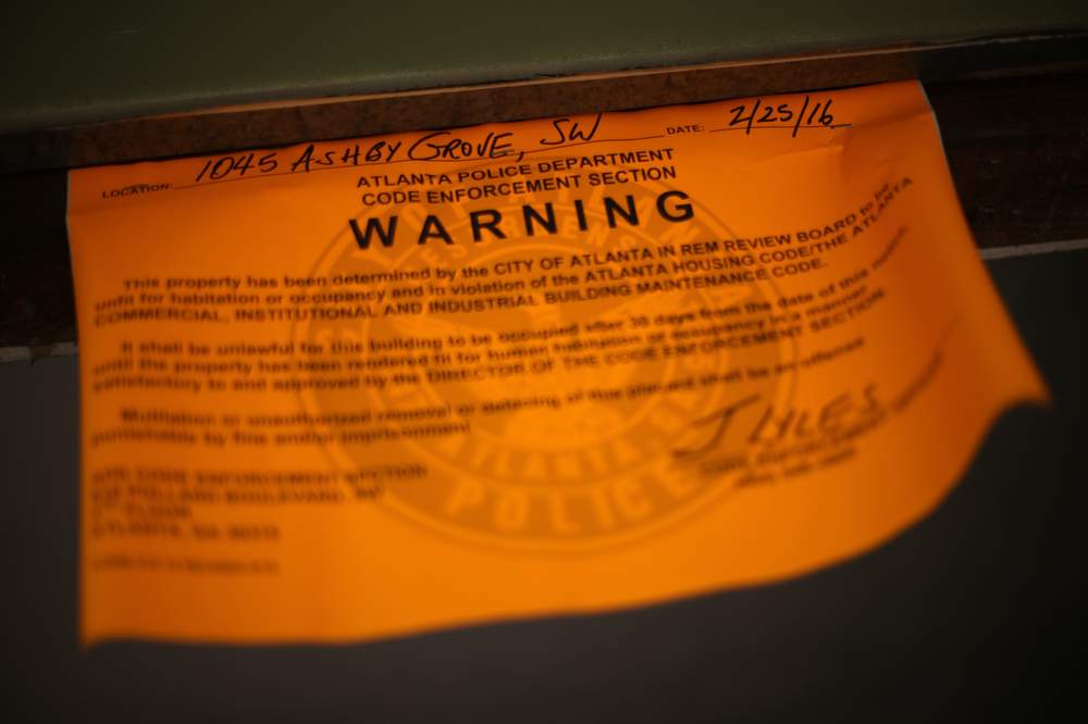 Taxpayers will have to pay to clean up or demolish 1045 Ashby Grove because authorities cannot find its owner. BEN GRAY \/ BGRAY@AJC.COM