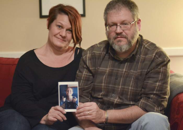 Suzanne and Tim hold a photo of Abigail.