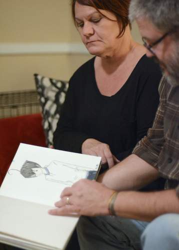 Suzanne and Tim take comfort browsing through sketch books Abigail left behind.