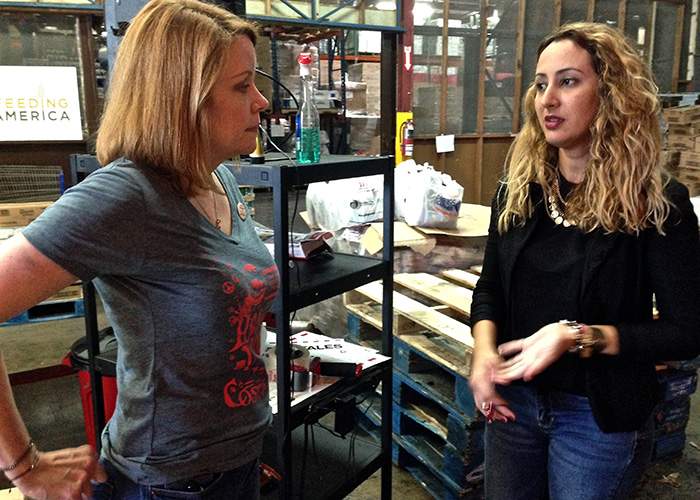 Shelly Williams Kuras (left) chats with Valerie Martínez, volunteer coordinator at the food bank. Suzanne Van Atten \/ svanatten@ajc.com