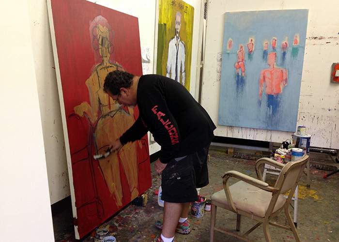 Artist Carlos Dávila Rinaldi’s studio was still without power five months after Hurricane Maria. Here he works on his new show “Aftermath,” featuring the portraits “Gas Man” and “Gas Woman,” and his painting “Departure.” Suzanne Van Atten \/ svanatten@ajc.com