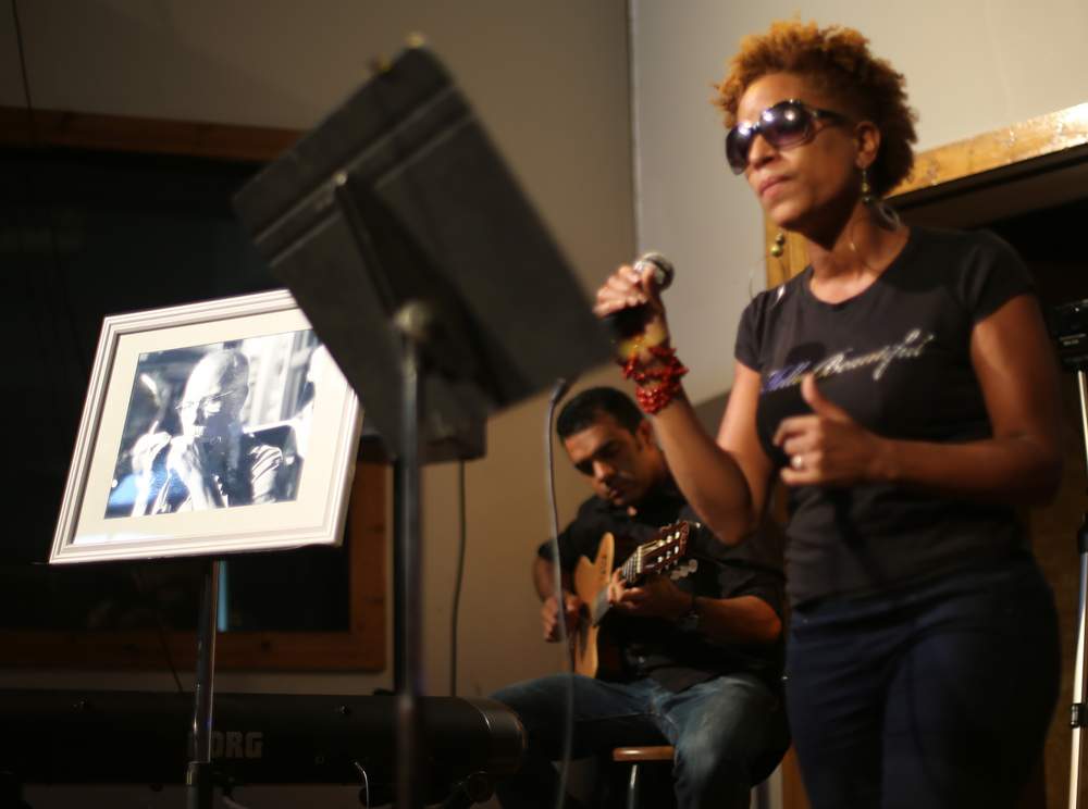 Julie Dexter sings one of Frank Barham's songs during a memorial and jam session in his honor May 27, 2015. Ben Gray \/ bgray@ajc.com