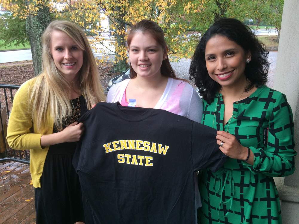 Felicia Villegas, center, celebrates her admission to Kennesaw State University with admissions counselor Meredith Head, left, and enrollment services specialist Zelda C. Ray. Photo: Jennifer Brett