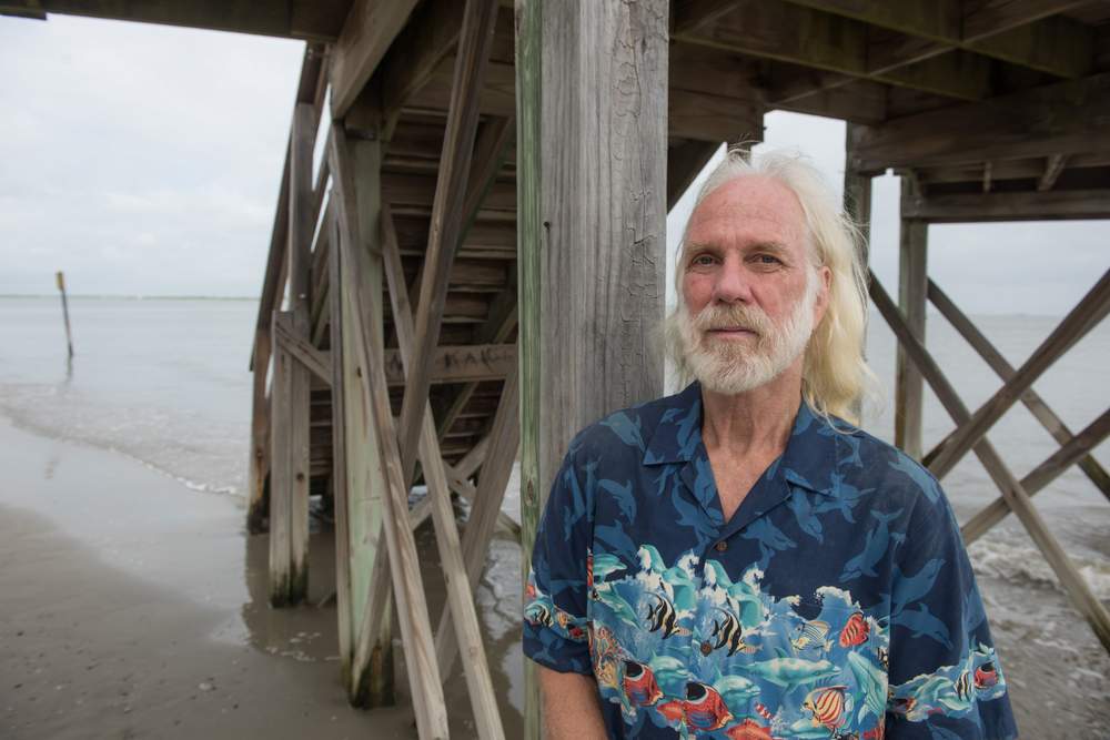 Tybee Island City Councilman and environmental activist Paul Wolff stands on a narrow strip of beach at the base of a wooden walkway on the north end of the island at high tide.PHOTO: John Carrington / Special