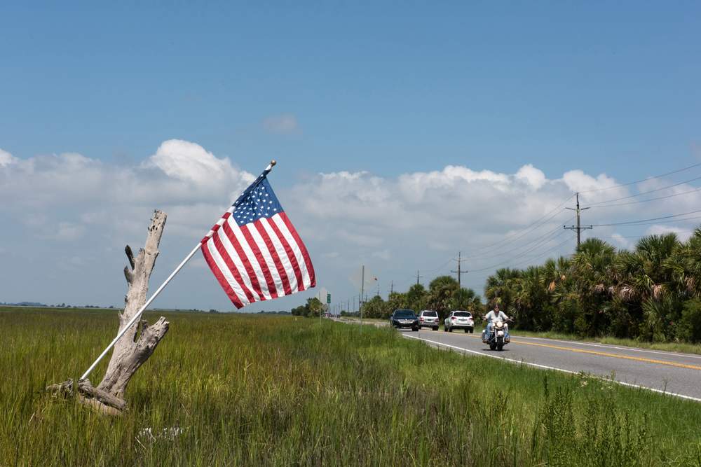 An American flag flies from a piece of driftwood in the marsh beside U.S. 80 along the causeway to Tybee Island, Ga.PHOTO: John Carrington / Special