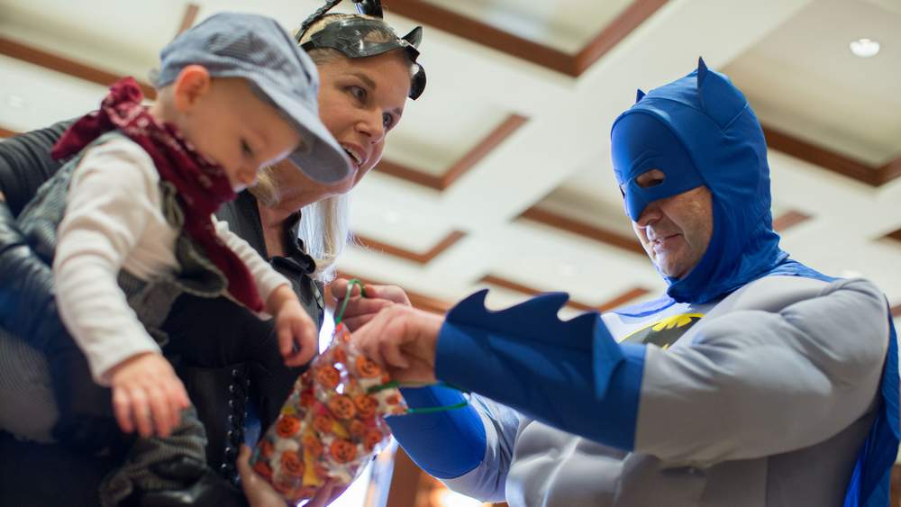 Little Lucas Norwood attended the Jackson Healthcare Halloween party where Melody and Rick Jackson dressed as Batgirl and Batman to hand out candy. Branden Camp