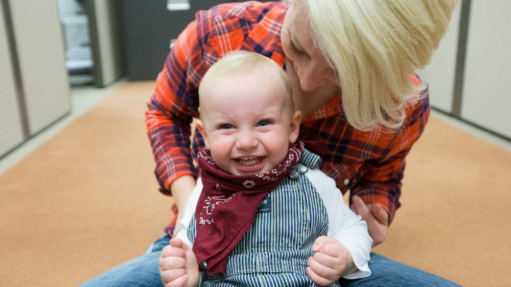 Carly Norwood holds her 17-month-old adopted son Lucas Norwood at Jackson Healthcare during an annual Halloween party for children in foster care. Branden Camp