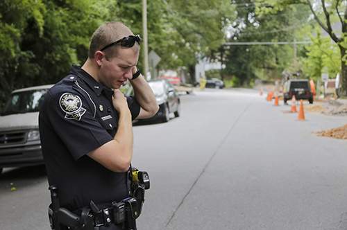 Troy Cosby reports in from the scene of a gas leak.  Construction workers installing fiber optic cable had hit a gas line. (BOB ANDRES \/ bandres@ajc.com)