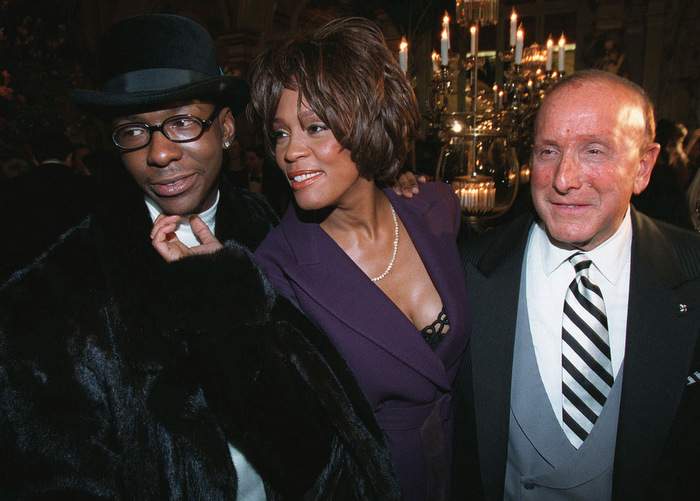 Bobby Brown, Whitney Houston and Clive Davis at a pre-Grammy party in 1998. AP Photo\/Stuart Ramson