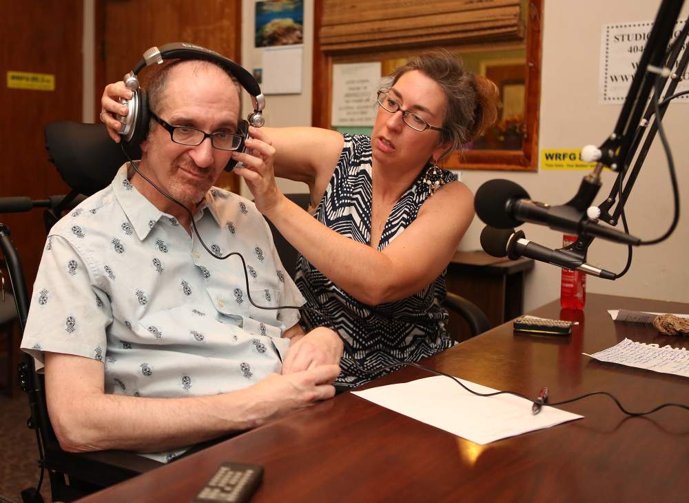 Greg Germani with girlfriend Beth Anne Harrill, as he prepares to guest host the Sagebrush Boogie on WRFG radio station with Dave Chamberlain. (Akili-Casundria Ramsess/Special to the AJC)