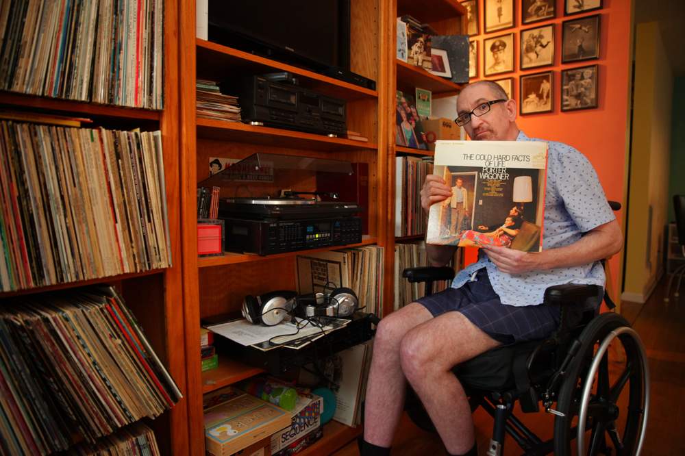 Greg Germani is a classic country music lover and has the record collection to prove it. Here he listens to some of his favorites in his Decatur home. (Sean McNeil)