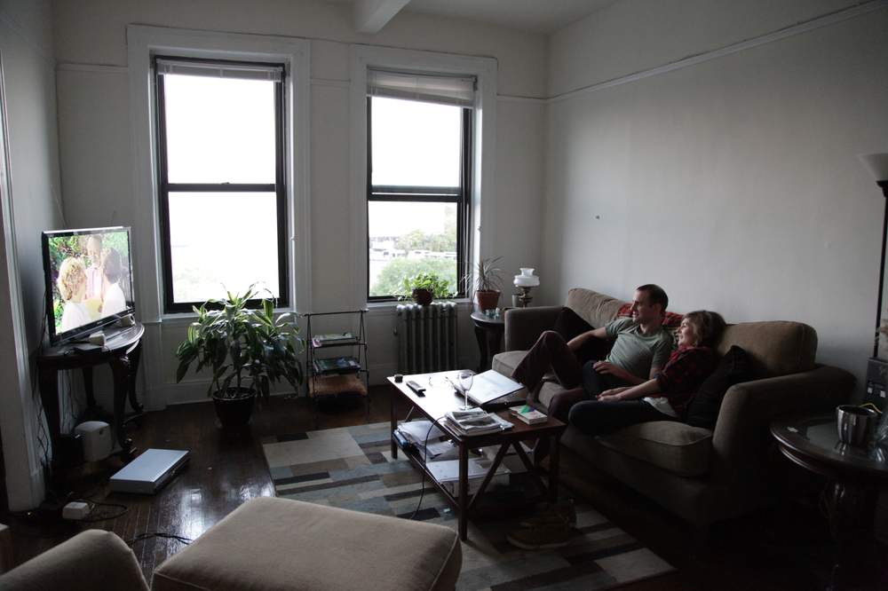 Jeff Ernsthausen and his fiancee Sally Larsen watch a video of a wedding officiated by his uncle,  Richard Heyman. Photo credit: Paul Abowd